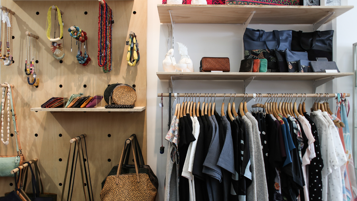 A closet filled with lots of clothes and handbags